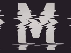 the letter m is reflected in water