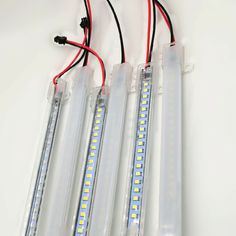 three leds are attached to the back of some type of light that is white