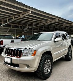 a silver jeep parked in front of a building