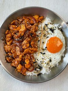 a plate with rice, chicken and an egg on it