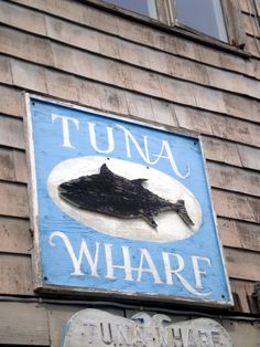 a sign on the side of a building that says tuna wharf and turnip whale