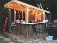 an outdoor bar with lights on the roof