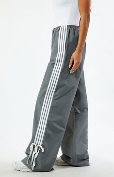 Step into athleisure vibes with the PacSun Dark Grey Wide Leg Track Pants. These trendy track pants combine comfort and style with a wide-leg silhouette, stripes down the leg, and ties at the ankles, offering a versatile and laid-back addition to your wardrobe, perfect for casual outings or cozy days at home.


	11.5" rise
	31.5" inseam
	23" leg opening
	High-rise
	Elastic waistband
	Stripes down the legs
	Tie detail at the ankle
	Side hand pockets
	Wide leg opening
	Relaxed fit Wide Leg Track Pants, Track Pants Women, Indie Brands, Pant Shirt, Skirted Swimwear, Short Rompers, Dress Romper, Basic Tees, Hoodie Dress