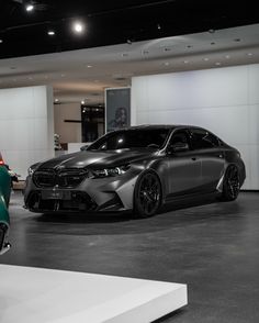 two cars are parked in a showroom