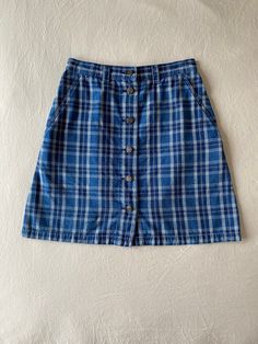 Details:  90s, liz wear, blue plaid button down mini skirt Condition:  Item is in excellent condition with no noted flaws *(this skirt has been washed and sanitized) Measurements: (all measurements taken flat in inches, then doubled where appropriate) Waist: 28 Hip: 36 Length: 19 Label Size: 10 (this would fit more like a modern-day size 6) Fabric Content:  100% cotton Care Instructions: Machine wash cold with like colors, tumble dry low heat or hang dry Return Policy: I do not accept returns, h Blue Retro Cotton Skort, Retro Blue Cotton Skort, Plaid Cotton Skirt For School, School Plaid Cotton Skirt, Cotton Plaid Skirt For School, Plaid Cotton Mini Skirt Skort, Plaid Cotton Mini Skort, Blue Button-up Cotton Denim Skirt, Blue Cotton Button-up Denim Skirt