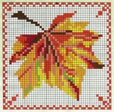 a cross stitch pattern with an orange and yellow leaf on the bottom, in red and white squares