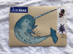 a stamp with a drawing of a blue whale on it's back and the words airmail written below