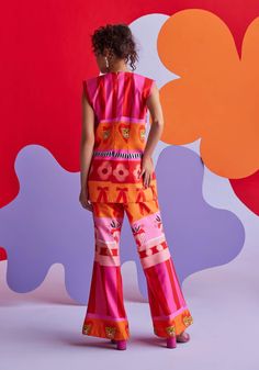 Imagine yourself in a tropical paradise, wrapped in the cheerful charm of pink and orange cotton floss pants. These vibrant hues capture the essence of a sunset, perfect for lounging by the beach with a refreshing cocktail in hand. The soft, airy fabric promises ultimate comfort and a playful touch, making every moment by the shore a little more delightful. Cheers to sun-kissed days and carefree vibes! Note: Top is for styling purposes only and can be purchased separately Playful Pink Cotton Pants, Vibrant Pink Bottoms For Vacation, Vibrant Pink Vacation Bottoms, Orange Summer Beach Pants, Summer Beach Pants In Orange, Summer Orange Pants For Vacation, Vibrant Print Pants For Vacation, Vibrant Pink Bottoms For Summer, Summer Pink Cotton Pants