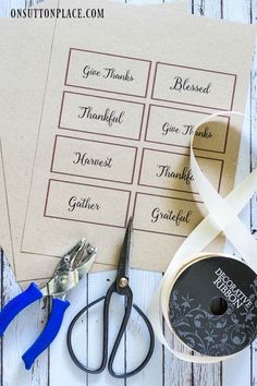 some crafting supplies are laying out on a white wooden table with the words give thanks written on them