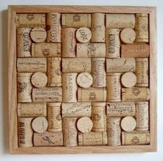 a wooden box with wine corks in it on a white wall next to a bottle opener