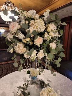 a vase filled with white flowers on top of a table