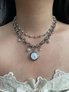 This vintage-inspired silver watch necklace choker combines elegance with a touch of grunge. Featuring a delicate pearl-adorned watch and a sleek silver chain, it's a unique Y2K-style accessory that adds a timeless charm to any outfit. Perfect as a statement piece for special occasions or as a thoughtful and distinctive wedding gift. - The watch is functional - Material: Titanium alloy pendant chain - Necklace length: 36cm + 6cm extension chain - Free shipping - Handcrafted, custom sizes available upon request - Packaged in a beautifully designed gift box, perfect for gifting - Order processing time: 3-5 days Watch Necklace Choker, Vintage Silver Watch, Watch Choker, Necklace Grunge, Clock Necklace, Pearl Watch, Choker Necklace Silver, Grunge Jewelry, Recycled Jewelry