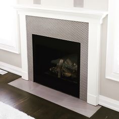 an empty fireplace in a white living room