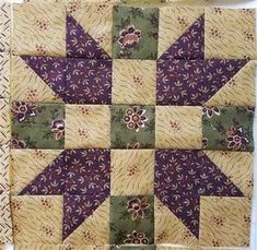 a quilted wall hanging with flowers on it