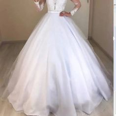 a woman in a wedding dress taking a selfie