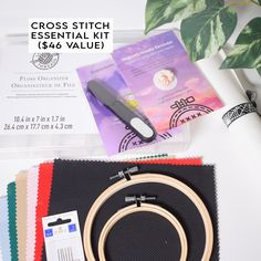 the cross stitch essential kit is on display