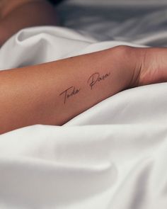 a woman's arm with a tattoo that reads, to be loved on it