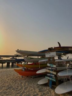 several surfboards are lined up on the beach at sunset or sunrise, and there is no image here to provide a caption for