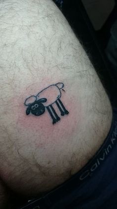 a man with a sheep tattoo on his stomach