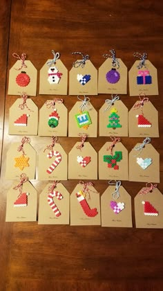 small tags with christmas decorations on them are laid out on a wooden table, ready to be used as place cards