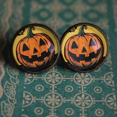 Have a very happy Halloween with our vintage inspired Jack O Lantern earrings.  Designed in the spirit of retro mid century Halloween decor, our Jack O Lantern earrings are the prefect way to add a touch of whimsy to your fall wardrobe. Image area 16mm (about the size of a dime).   Handmade in a home studio. Glass cabochon jewelry like these retro Halloween earrings are water resistant but not water proof.  Do not wear while bathing or swimming.  Wipe clean with a soft cloth. Thank you for supporting small business! Mid Century Halloween, Vintage Jack O Lantern, Glass Cabochon Jewelry, Lantern Earrings, Jack O'lantern, Cabochon Jewelry, Halloween Earrings, Retro Mid Century, Retro Halloween