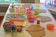 the table is covered with crafting supplies for kids to make their own art projects