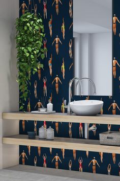 a bathroom with a sink, mirror and wallpaper on the walls in different colors