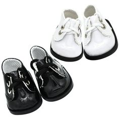 three pairs of white and black baby shoes