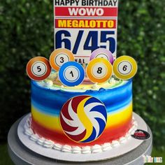 a multi - colored birthday cake with billiards on it and a happy birthday sign in the background