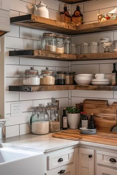 the shelves in the kitchen are filled with dishes and cooking utensils on them