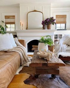 a living room filled with furniture and a fire place in front of a white fireplace