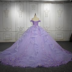 Elevate your special occasion with our Romantic Quinceanera Dresses. Adorned with exquisite 3D flower appliques and delicate beading, our ball gown will make you feel like a princess. Perfect for prom or quinceanera, the intricate detailing adds a touch of romance to this stunning dress. Purple Gown For Debut, Purple Ballgown, Lavender Quinceanera, Lavender Quince, Purple Quince, Formal Wedding Guest Dress, Formal Wedding Guests, Pretty Quinceanera Dresses, Luxurious Dresses