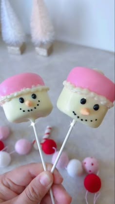 there are two marshmallows that look like snowmen with pink hats on them