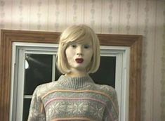 a mannequin is standing in front of a window