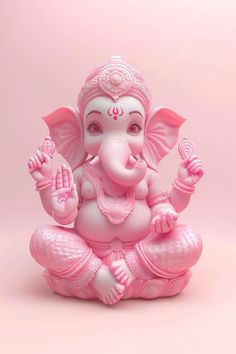 an elephant statue sitting on top of a pink surface