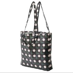 a black and white polka dot tote bag on a white background with the handles down