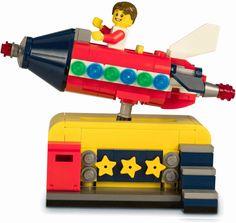 a small toy rocket with a man on top