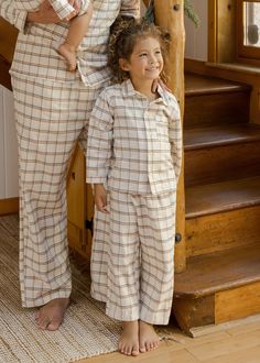 Our new pj set includes a soft long sleeve top and cozy pants. The top has a pocket at the front, and the pants have an elasticized waistband. Care: Machine wash cold. Tumble Dry low. Made of 60% modacrylic, 40% cotton Mommy And Me Pjs, Plaid Pajama, Cozy Pants, Holiday Plaid, Plaid Pajamas, Family Holiday, Christmas Pajamas, Pj Sets, Long Sleeve Top