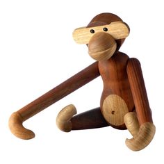 a wooden toy monkey sitting on the ground