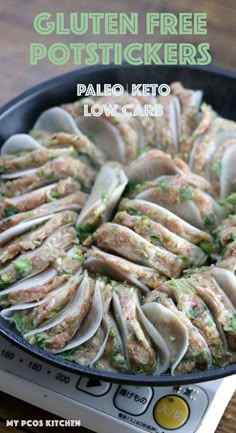 a skillet filled with meat and vegetables on top of a stove