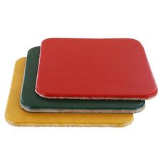 three different colored coasters sitting next to each other on a white surface with one red, one green and one yellow