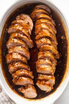 sliced pork with sauce in a white bowl