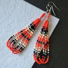 two pairs of beaded earrings on top of a piece of paper