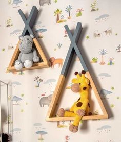 two wooden triangle shelves with stuffed animals on them in a child's room decorated with wallpaper