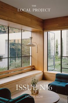 the cover of issue no 6 of the local project, featuring two blue chairs and a coffee table in front of large windows