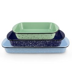 three blue and green dishes stacked on top of each other with speckles in them