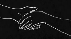 two hands touching each other over a black background