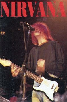 a man with red hair playing a guitar