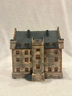 a toy house made out of clay on a white background