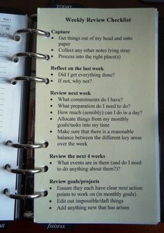 an open spiral notebook with some writing on the page and a list attached to it that says weekly review checklist